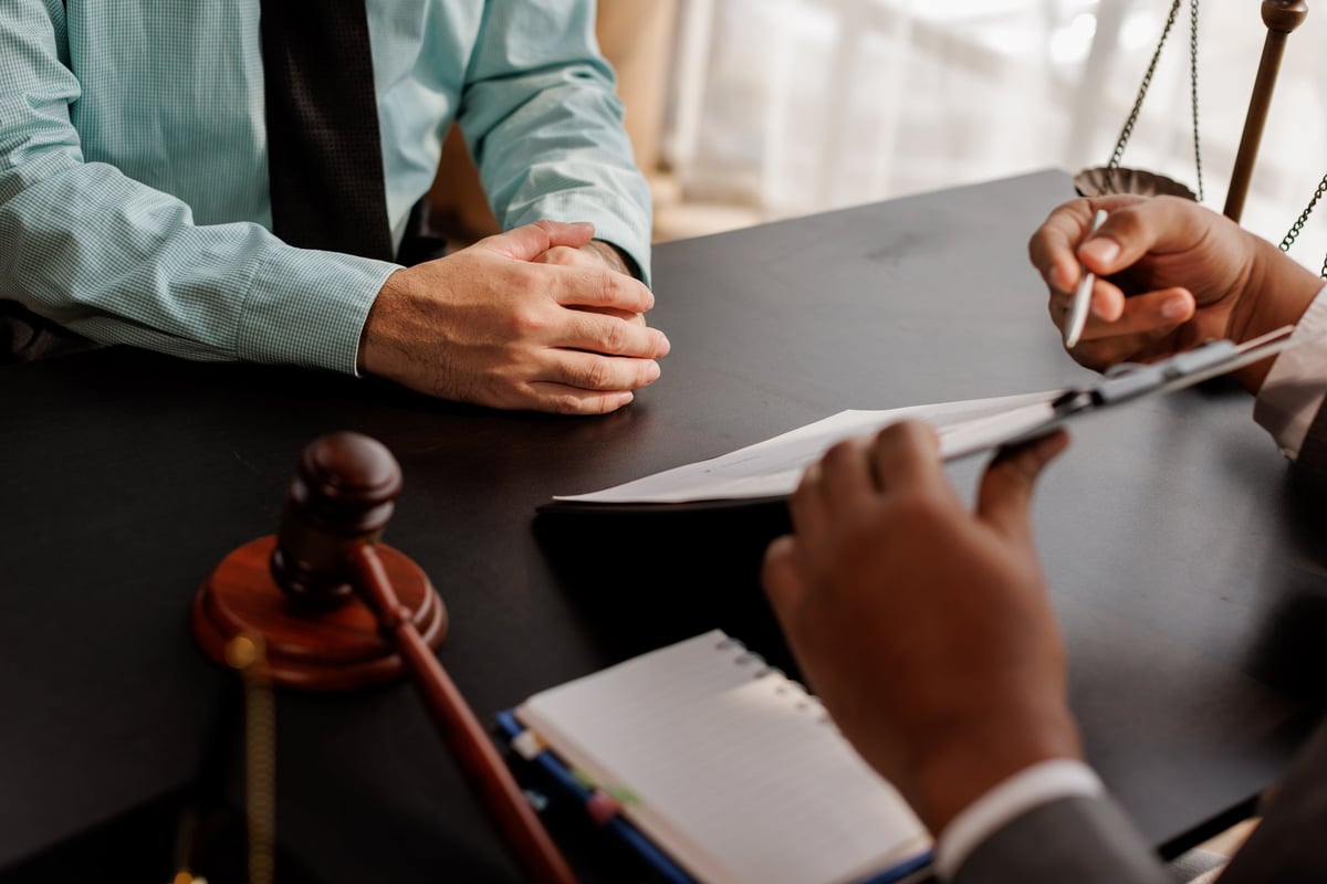 law and justice. Lawyer Legal counsel presents to the client a signed contract with gavel and legal law. justice and lawyer Business partnership meeting concept.