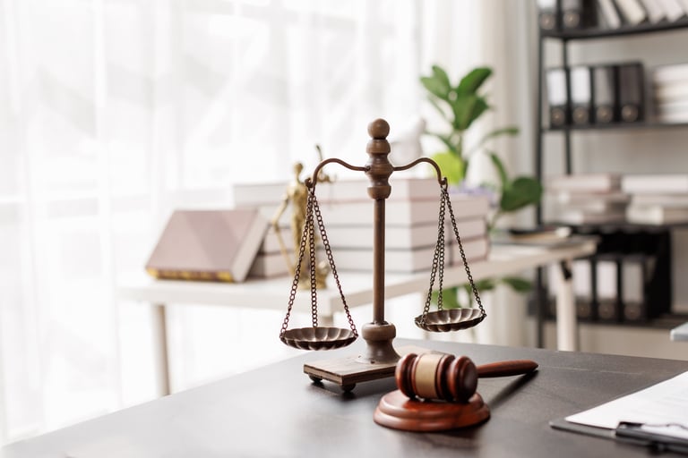Justice statue and legal documents on desk representing Turkish residence permit legal guidance and immigration services