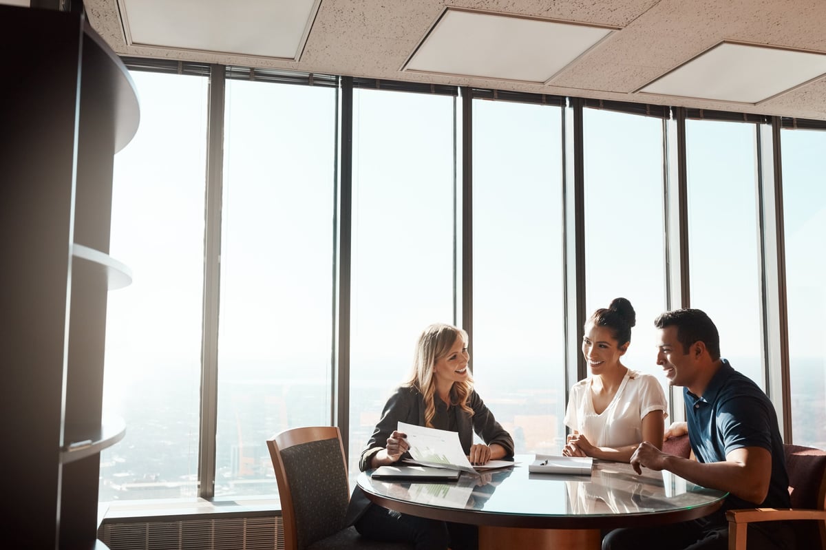 Financial advisor meeting with investors in modern office representing Turkish citizenship via bank deposit investment guide